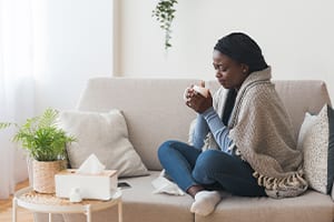 Smiling Casual Senior Woman Using Laptop While Talking On Smartphone.